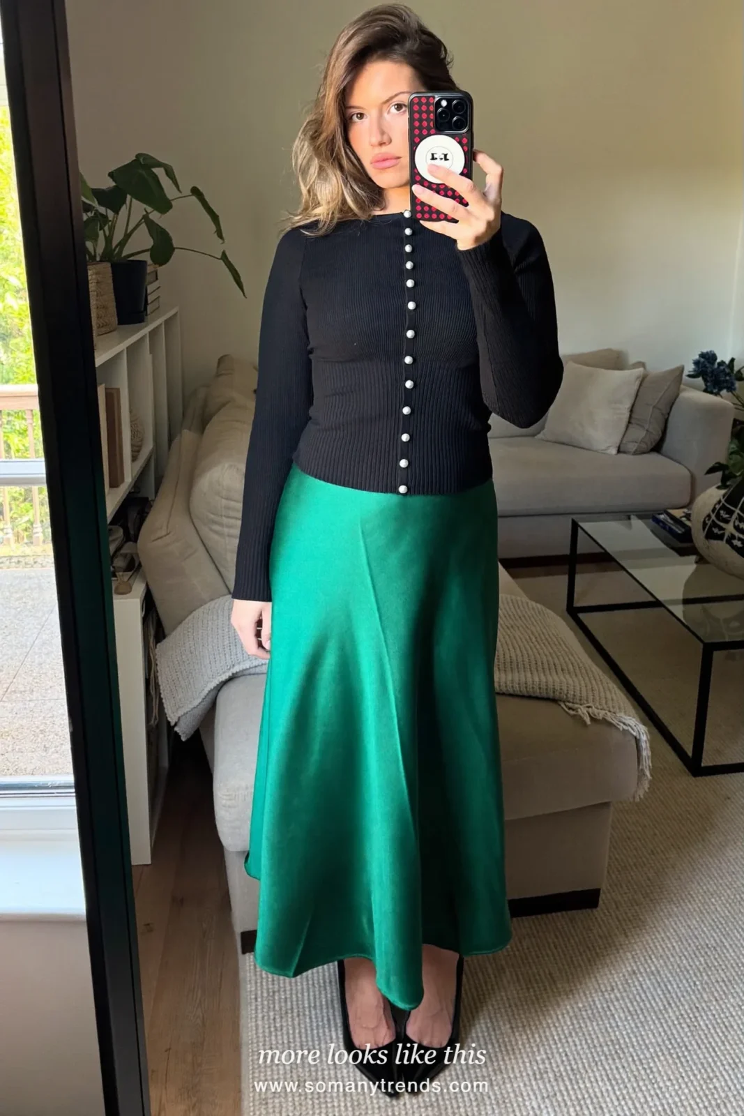 Black knit cardigan with pearl buttons worn as top, emerald silk midi skirt and heels, mirror selfie, outfit 12