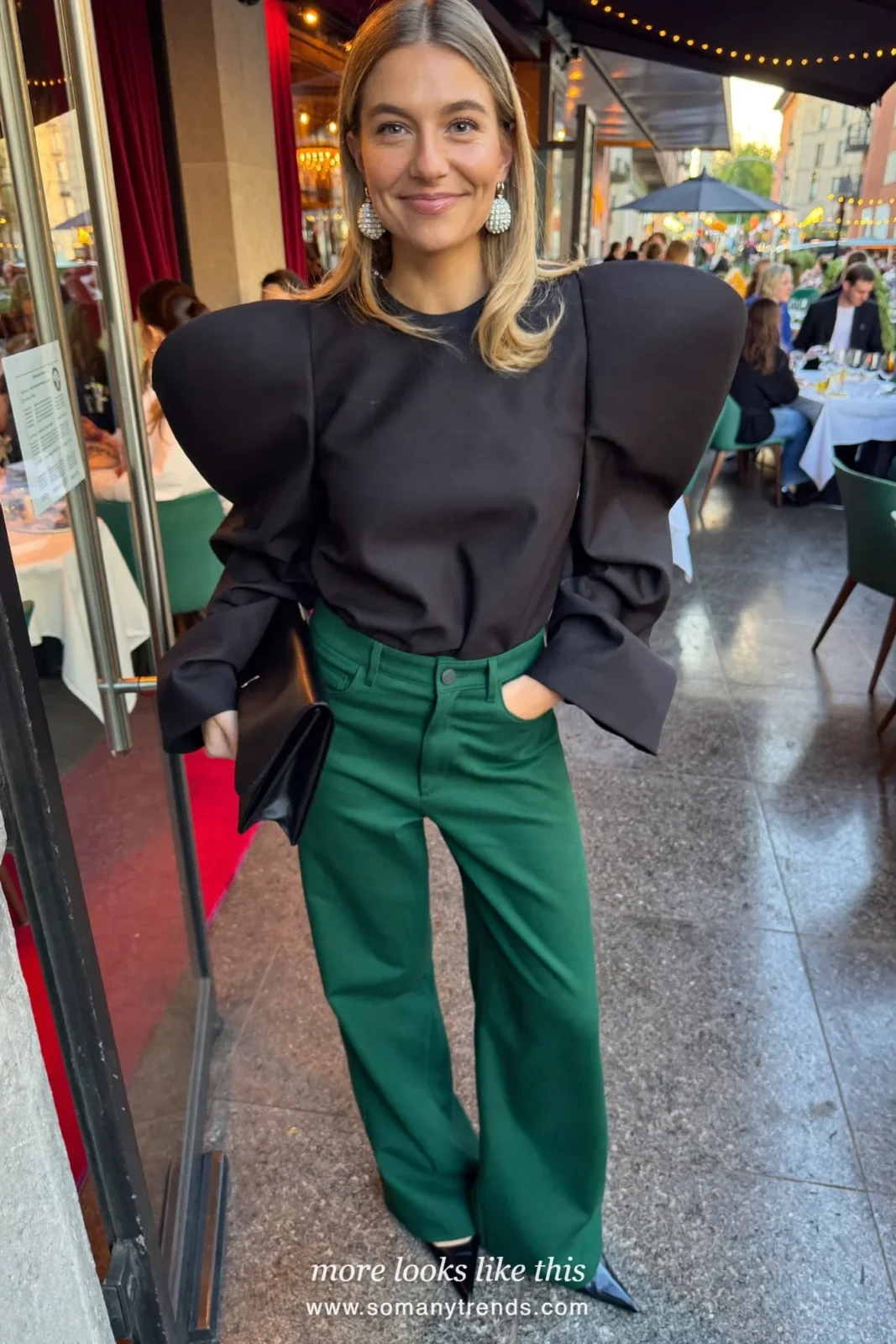 Black top with sheer sleeves and emerald wide pants, statement earrings and heels, outfit 23