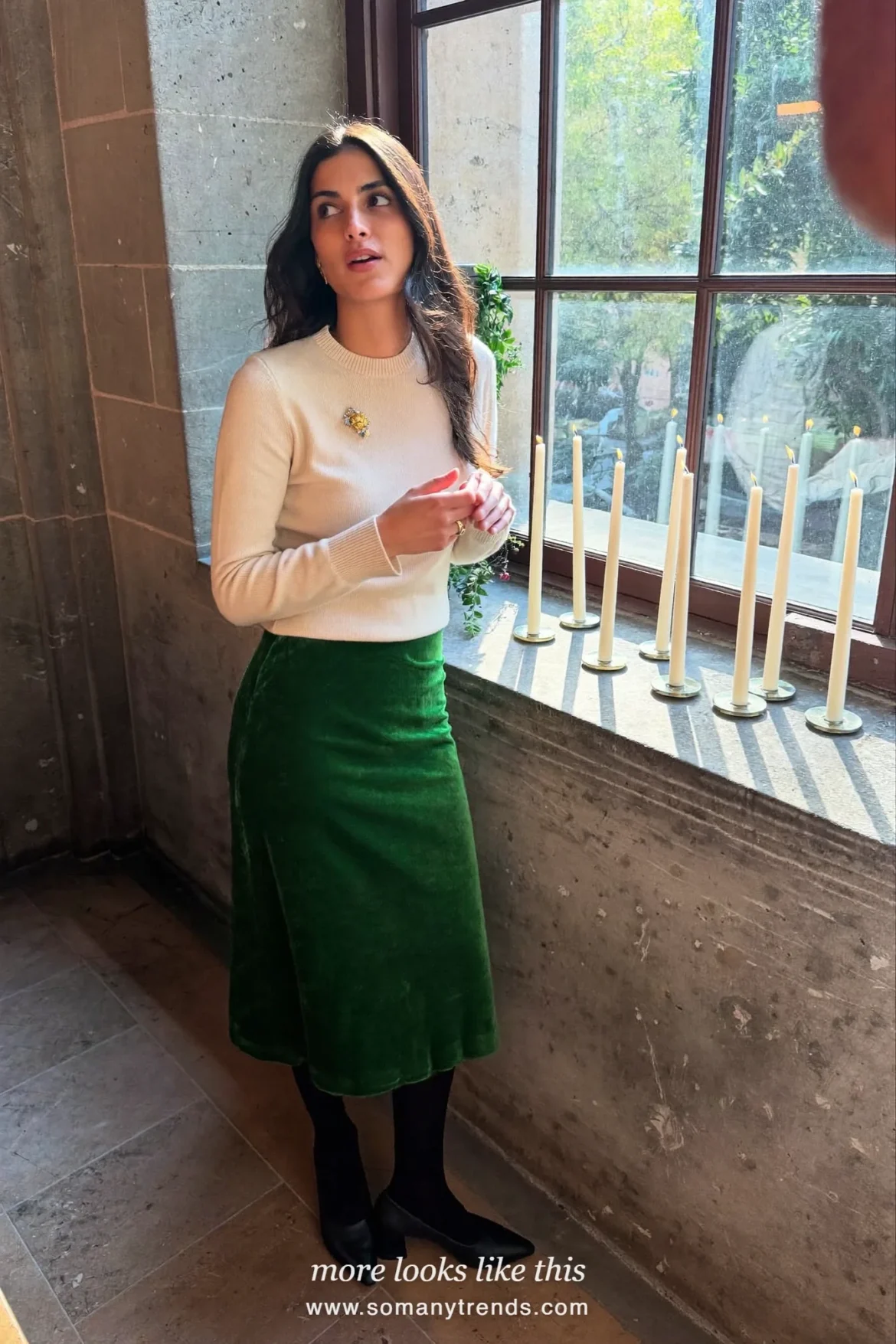 Woman in a forest green velvet midi skirt, cream knit sweater and black heels, church outfit 13