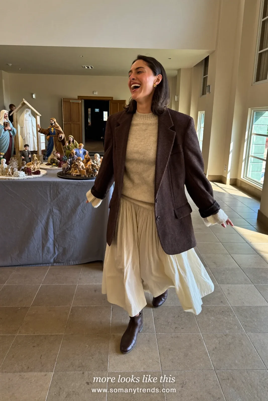 Woman in a chocolate brown blazer, cream midi skirt, fine knit and brown boots, church outfit 27