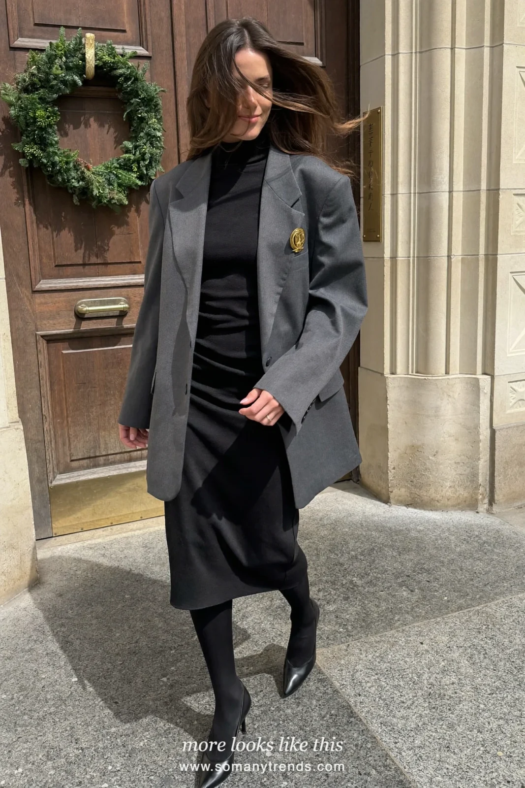 Woman in a charcoal blazer dress, black turtleneck, gold brooch and black pumps, church outfit 29