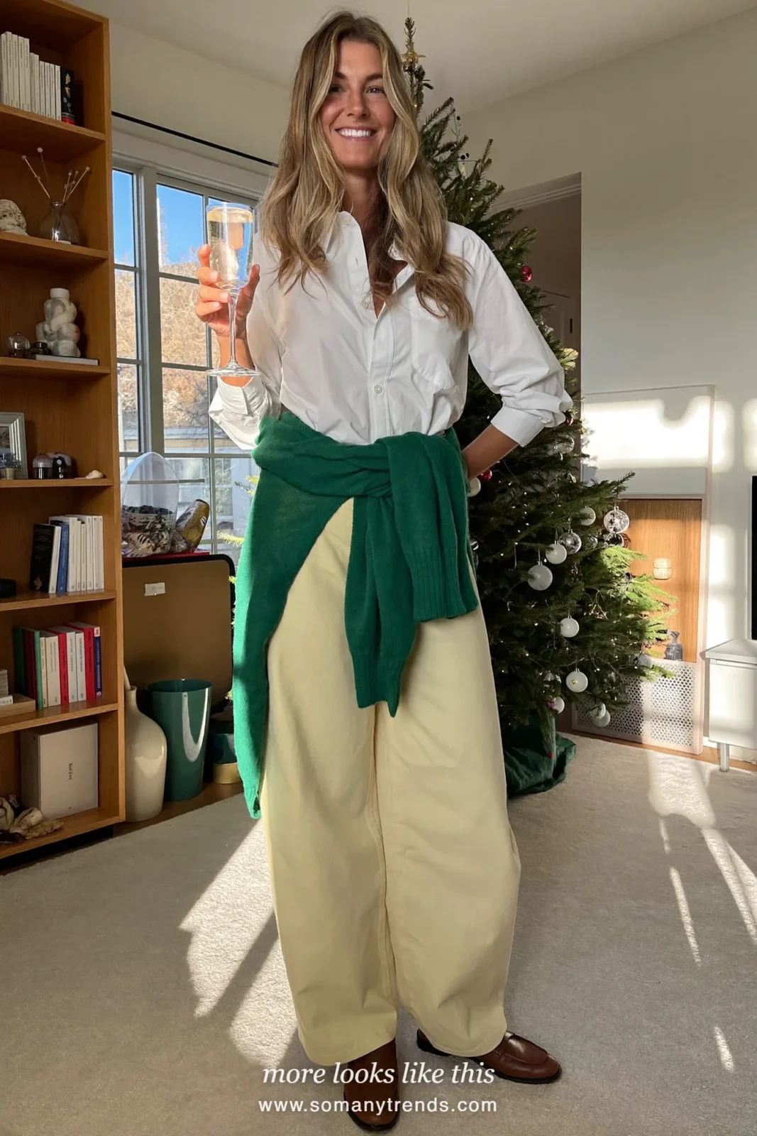 Forest green sweater tied at the waist over a white shirt with ecru pants and loafers, Christmas outfit 5