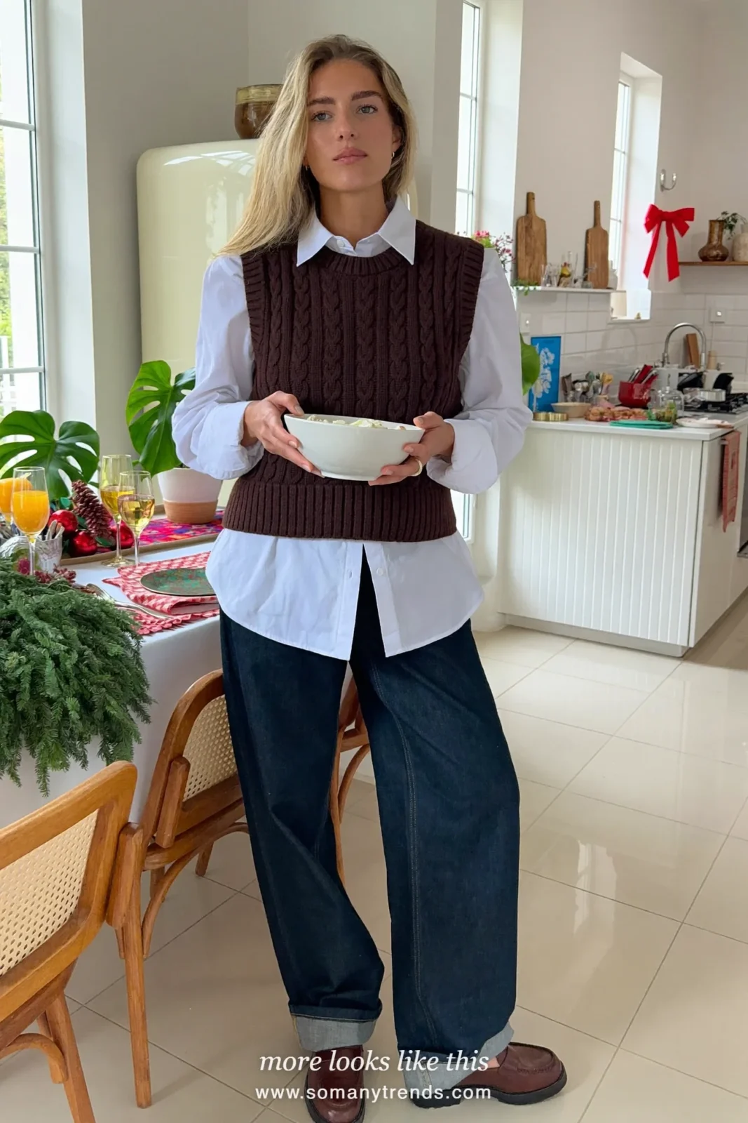 White poplin shirt under a chocolate cable knit vest with dark indigo jeans and loafers, Christmas outfit 13