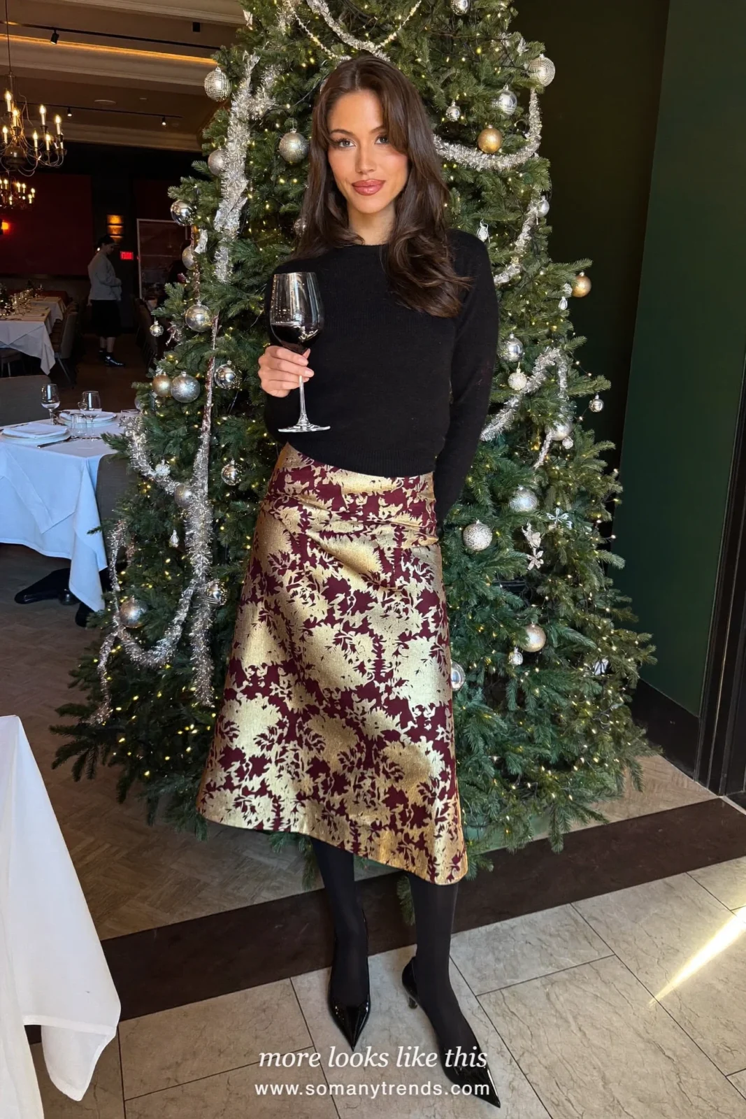 Woman in a gold and burgundy brocade midi skirt, fine black knit top and black pumps, outfit 2