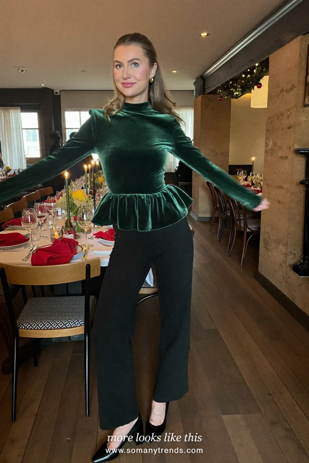 Woman in an emerald velvet peplum top, black wide-leg pants and black block-heel pumps, outfit 3