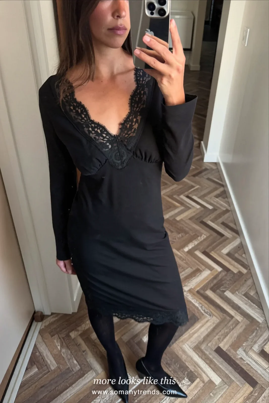 Woman in a black lace-trim long-sleeve midi dress with black tights and pumps taking a mirror selfie, outfit 20