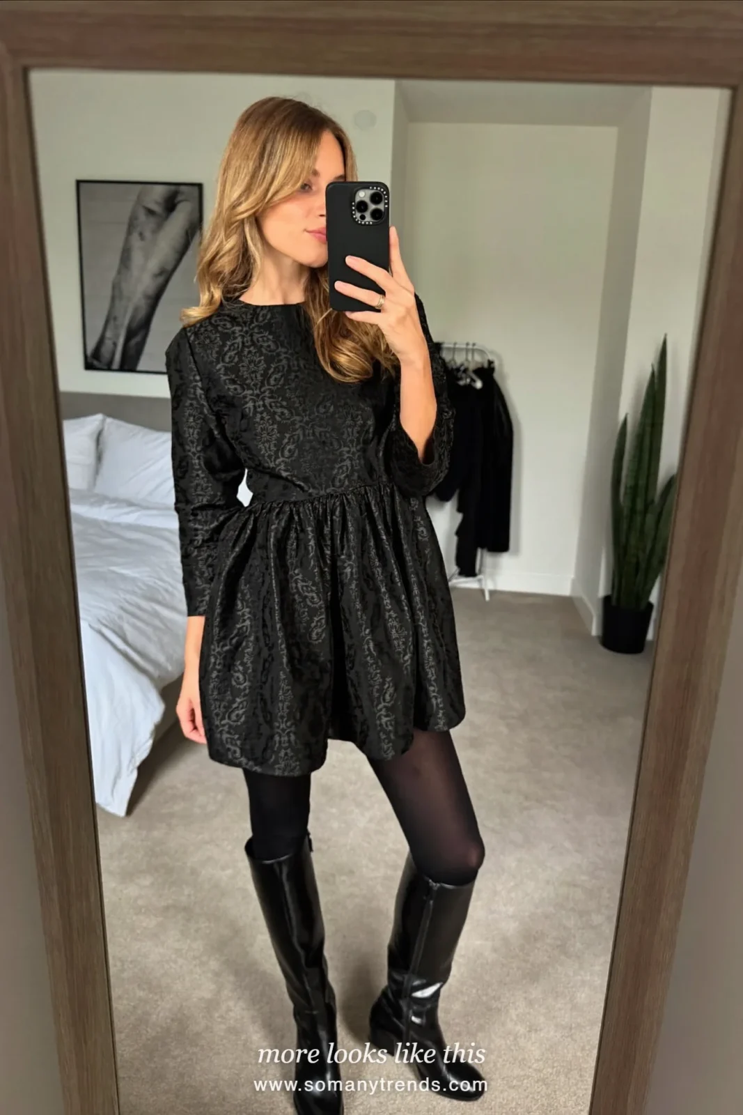Woman in a black brocade long-sleeve mini dress, opaque black tights and knee-high black boots, outfit 24