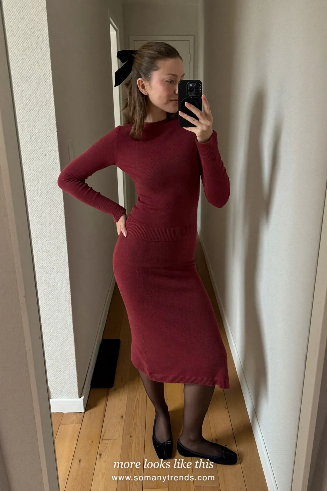 Woman in a burgundy knit top and midi skirt set with a velvet hair bow in a mirror selfie, church outfit 4