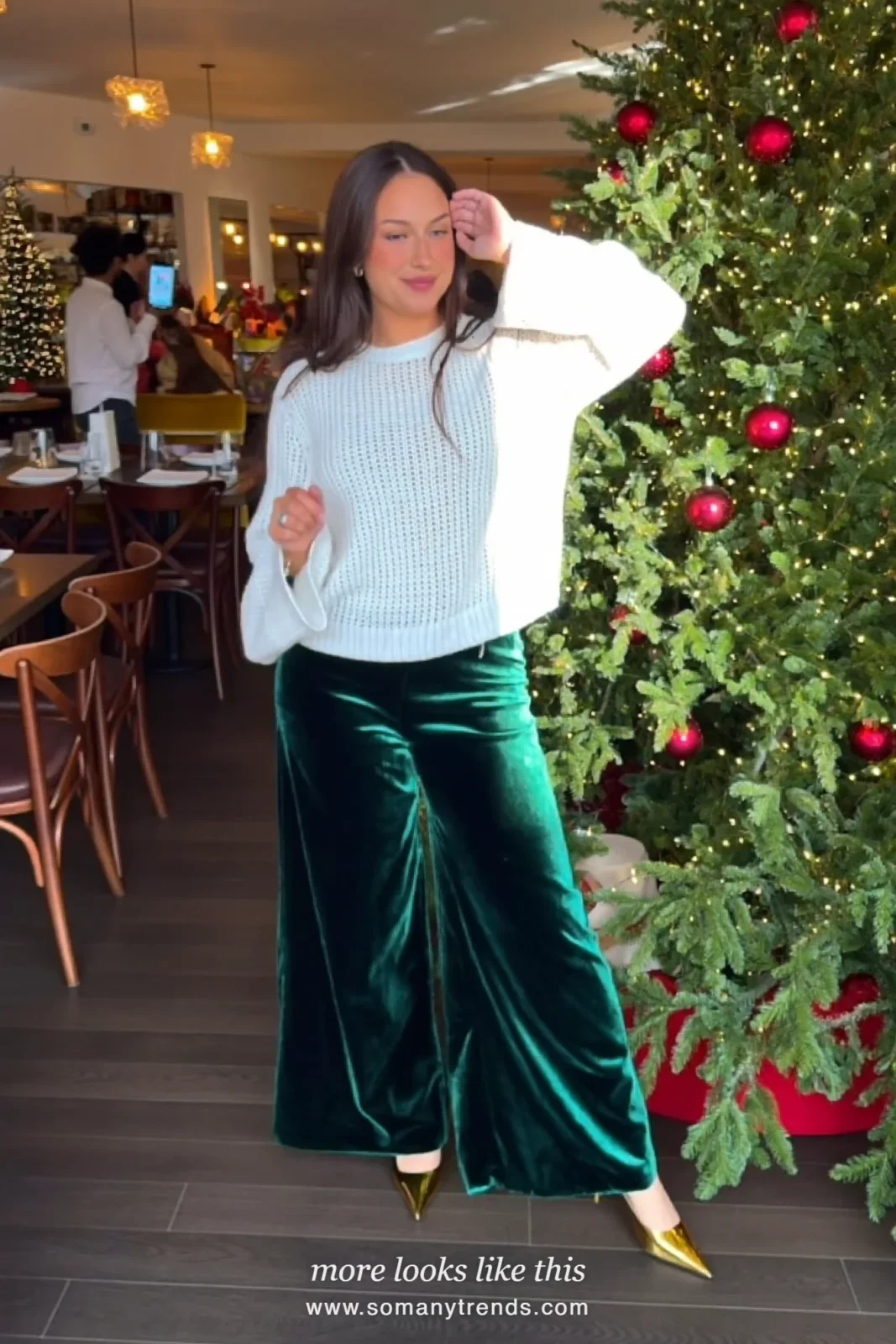 Woman in a white fine knit sweater, emerald velvet wide-leg pants and gold pumps, outfit 25