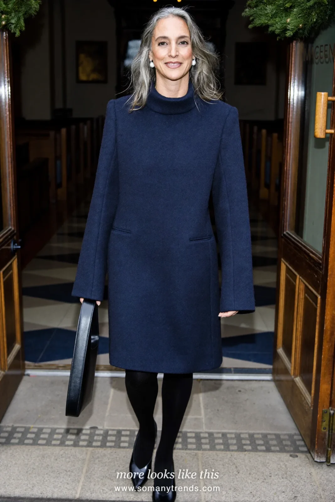 Woman in a navy long-sleeve wool dress, black sheer tights, closed pumps and pearl earrings at Christmas Eve service, outfit 6