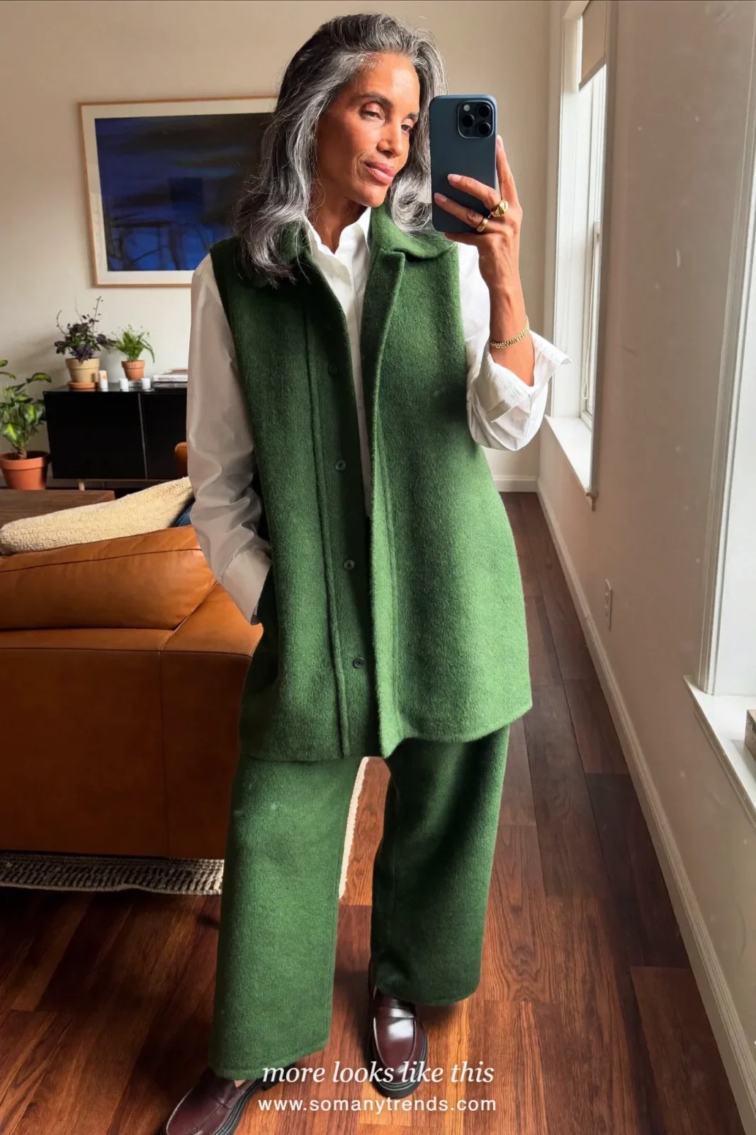 Woman in a forest green wool vest, white shirt, green straight pants and brown loafers at a holiday lunch, outfit 12