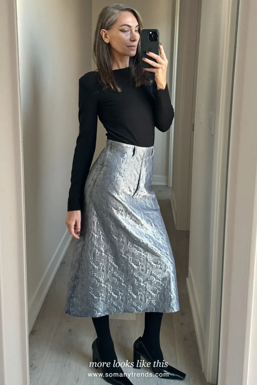 Woman in a black fine knit top, silver-blue jacquard midi skirt and block-heel pumps at a Christmas dinner, outfit 16