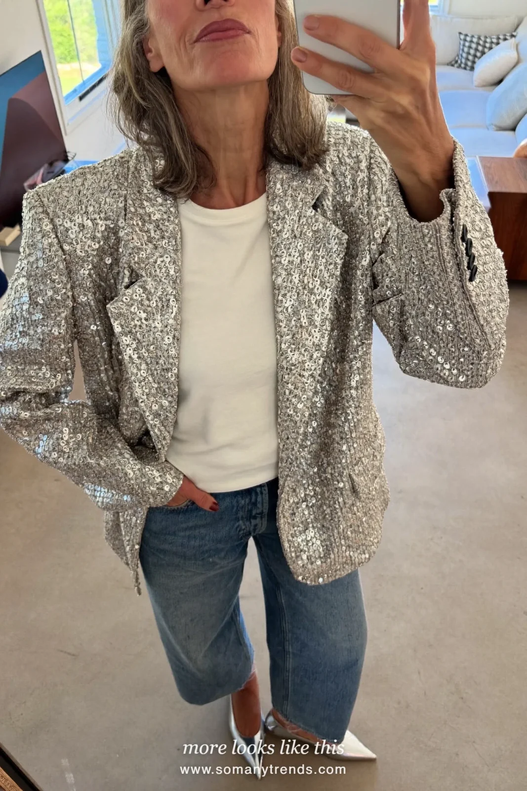 Woman in a silver sequin boxy jacket, white tee, wide-leg jeans and pointed flats at a holiday lunch, outfit 24
