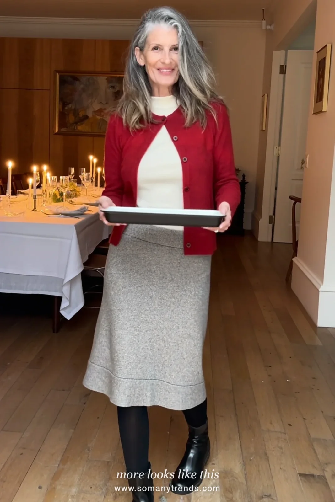 Woman in a cranberry cardigan, cream top, gray flannel midi skirt and low boots at a family Christmas brunch, outfit 25