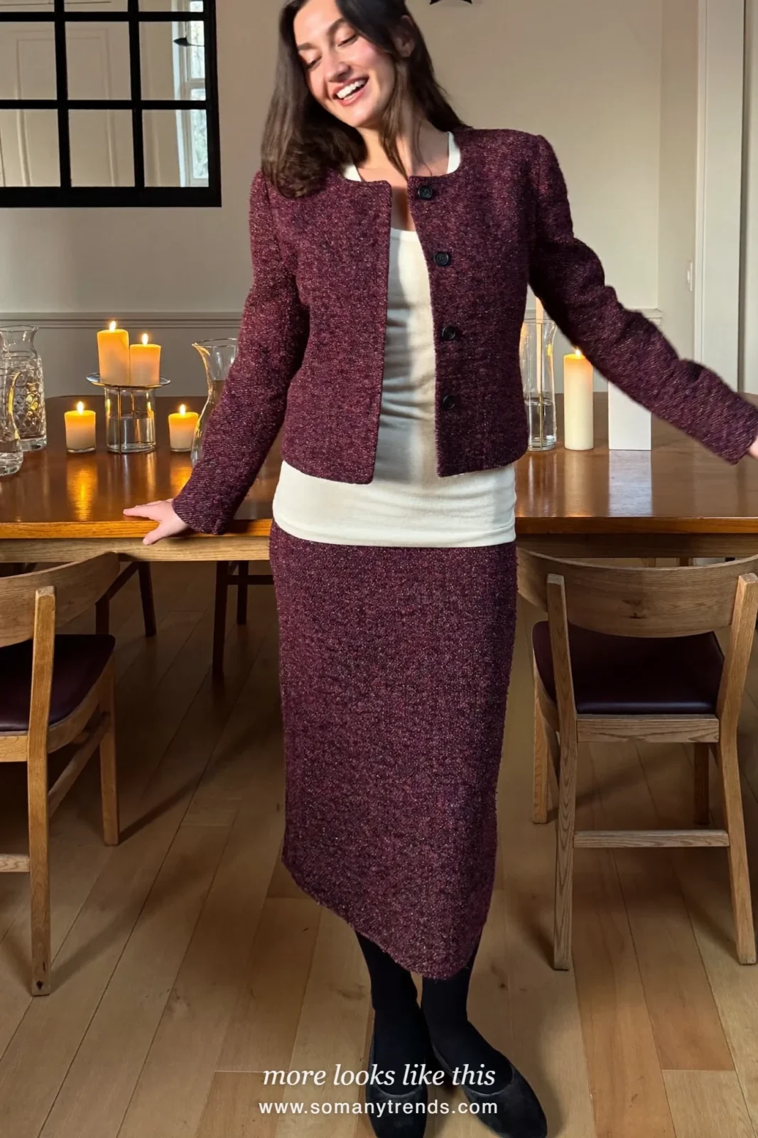 Woman in a burgundy tweed jacket and skirt set with cream tank and black flats at a dinner table, outfit 11