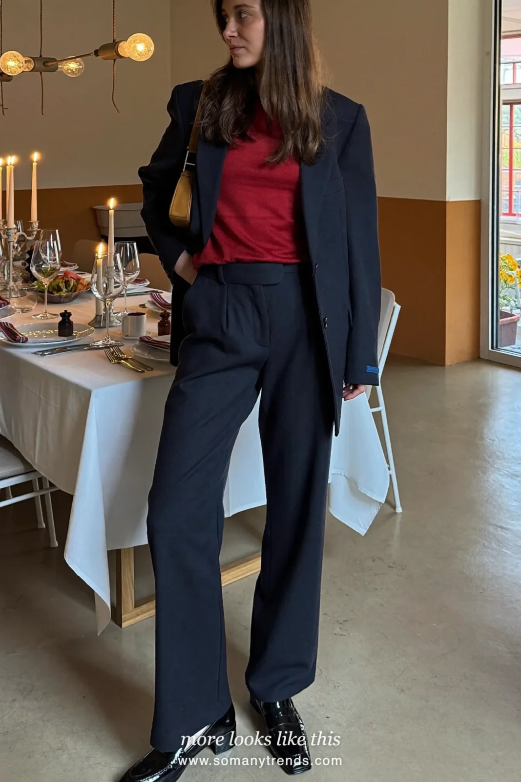 Woman in a navy blazer and wide pants suit with a deep red top and black heeled loafers at a dinner, outfit 30