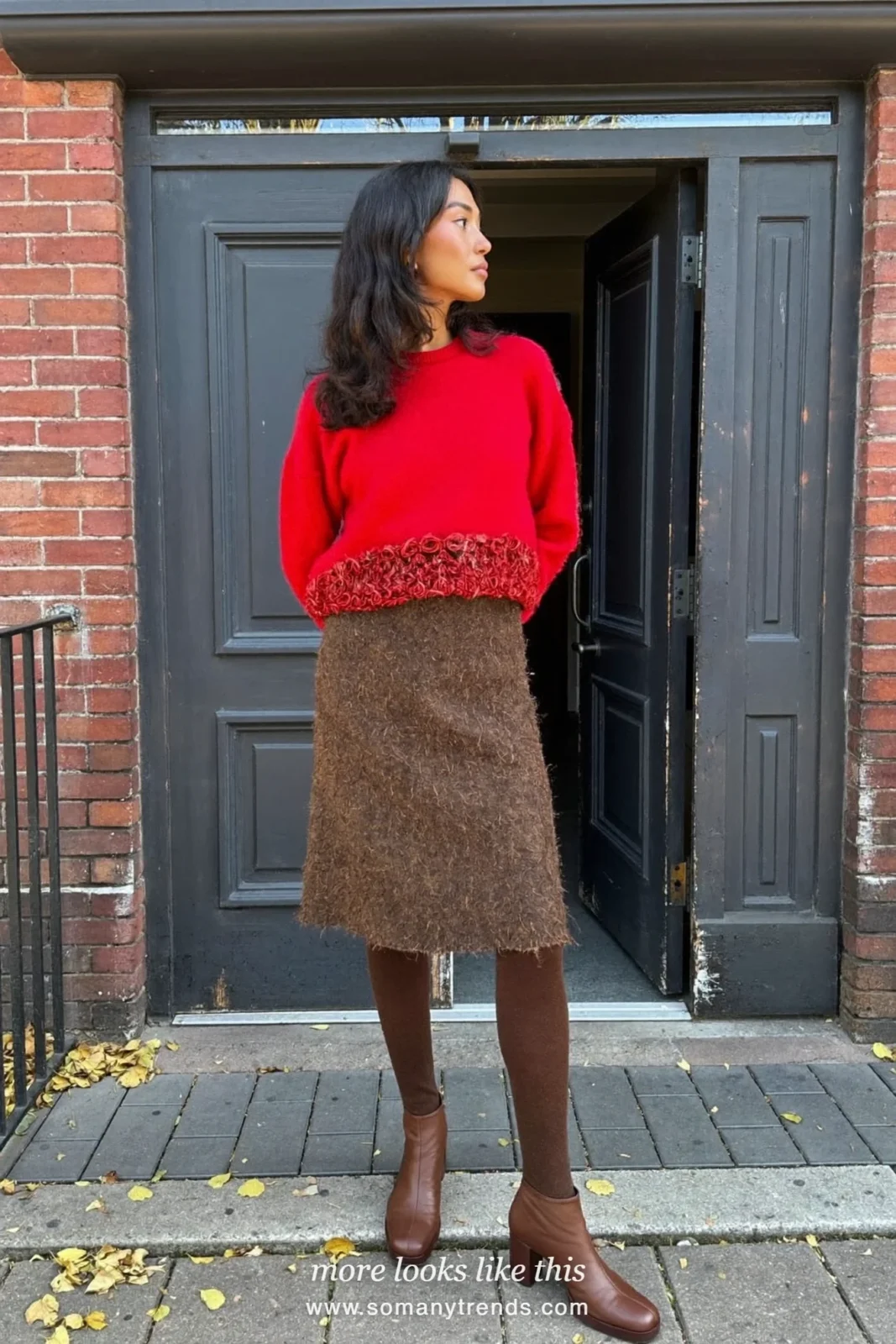 Woman wearing a red crewneck sweater, chocolate brown wool midi skirt, brown opaque tights and brown block-heel ankle boots, winter graduation outfit 2