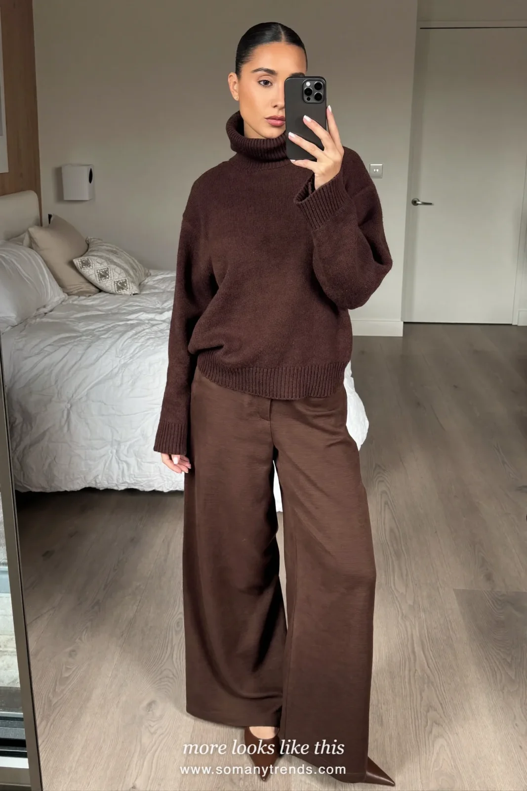 Woman wearing a chocolate brown fine-knit turtleneck, wide-leg chocolate brown pants and brown pointed flats, winter graduation outfit 8