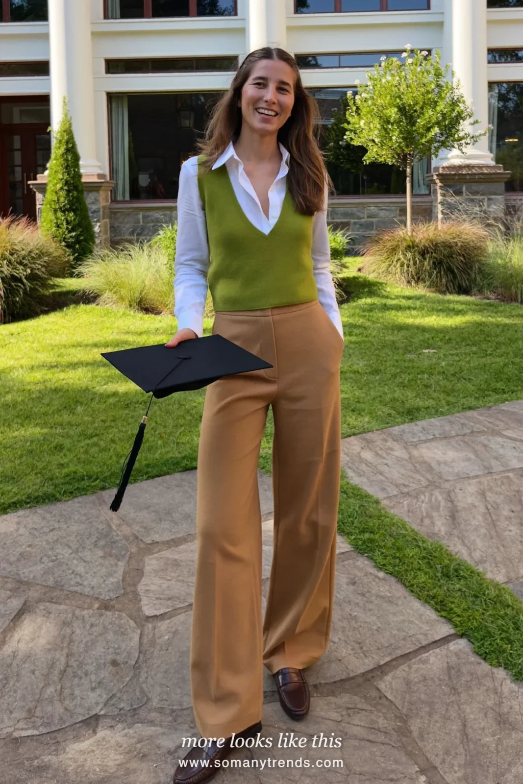 Woman wearing a white spread-collar shirt, pine green knit vest, wide-leg camel pants and brown low-heel loafers, winter graduation outfit 18