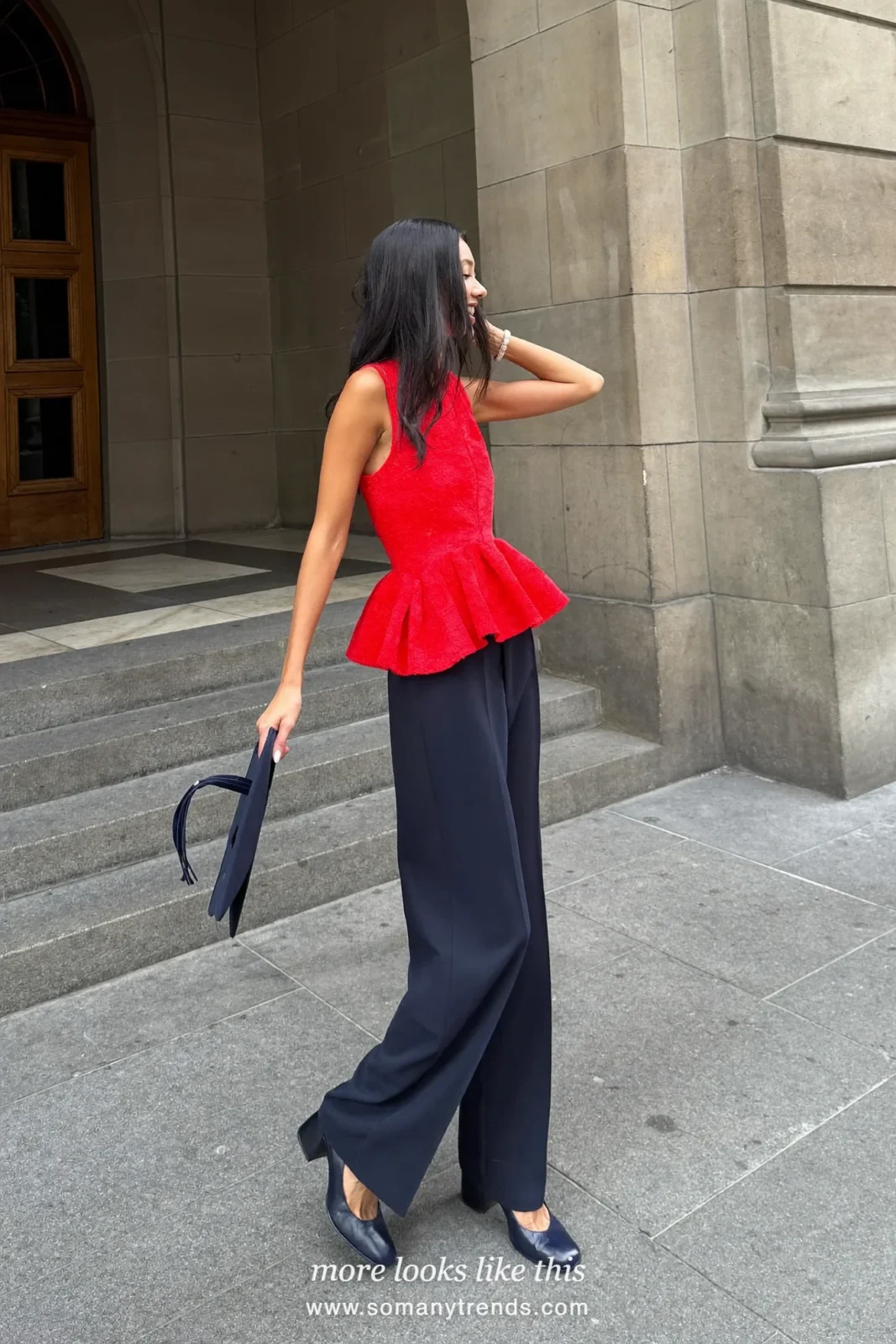 Woman wearing a red peplum top, wide-leg navy pants and navy block-heel pumps, winter graduation outfit 19
