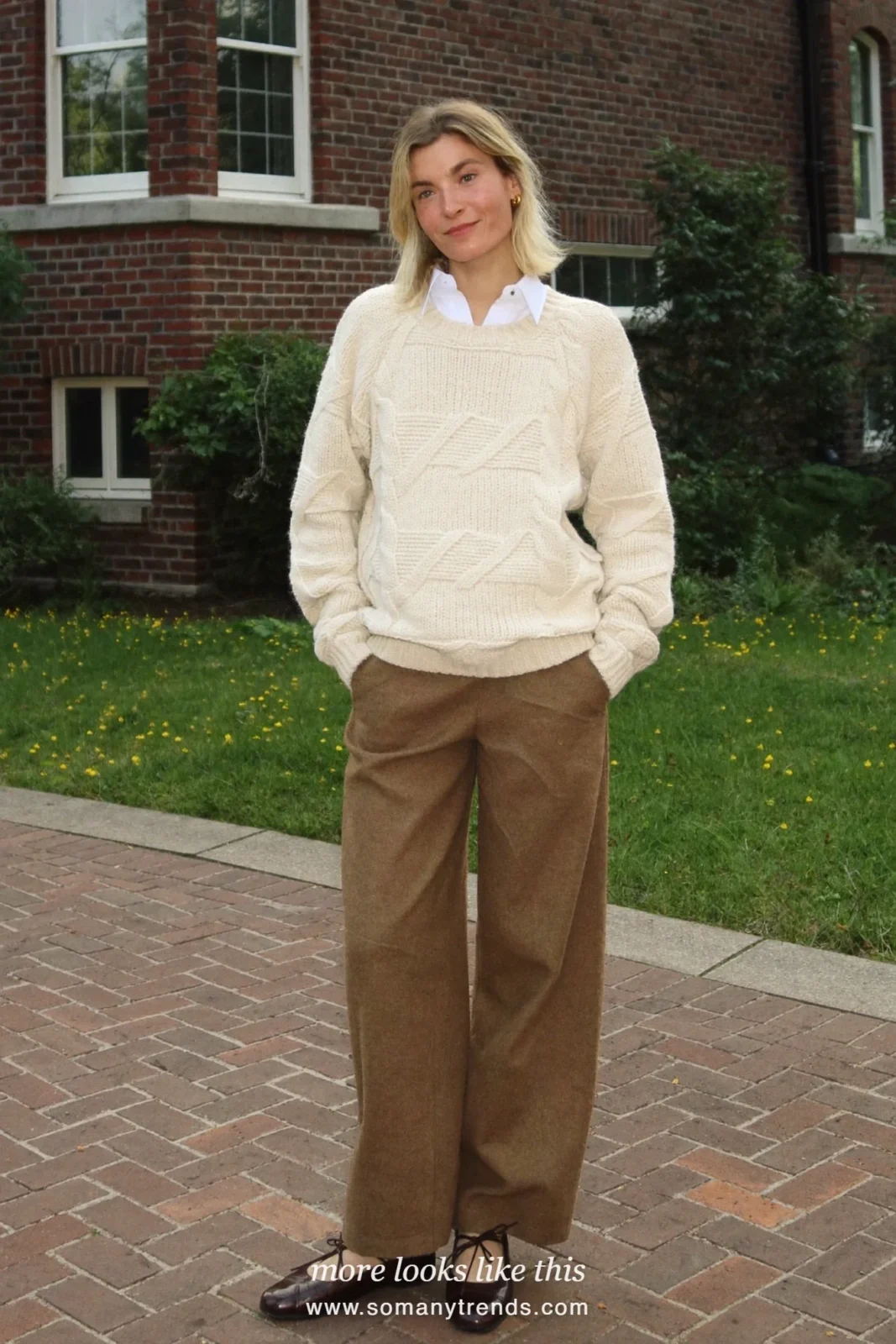 Woman wearing a cream cable-knit sweater over a collared shirt, wide-leg brown wool pants and brown leather lace-up flats, winter graduation outfit 22
