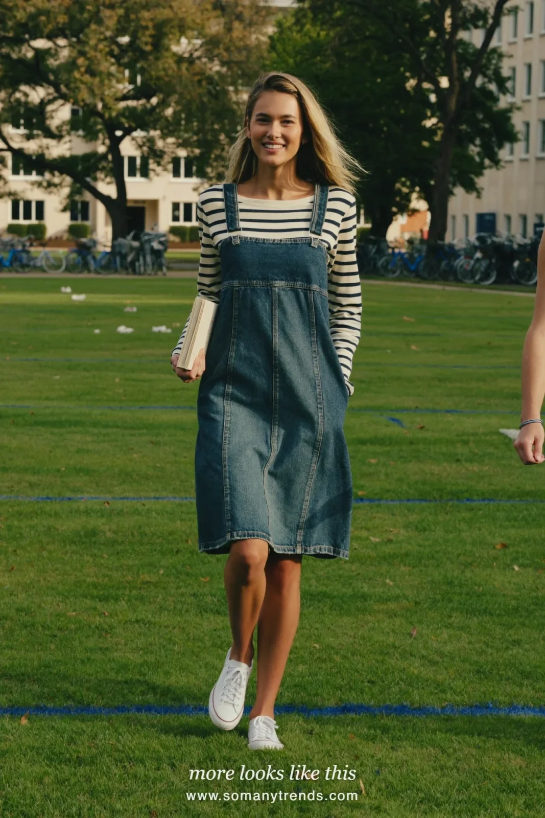 Faded denim midi pinafore dress over a navy and ivory striped long-sleeve tee with white sneakers, outfit 14