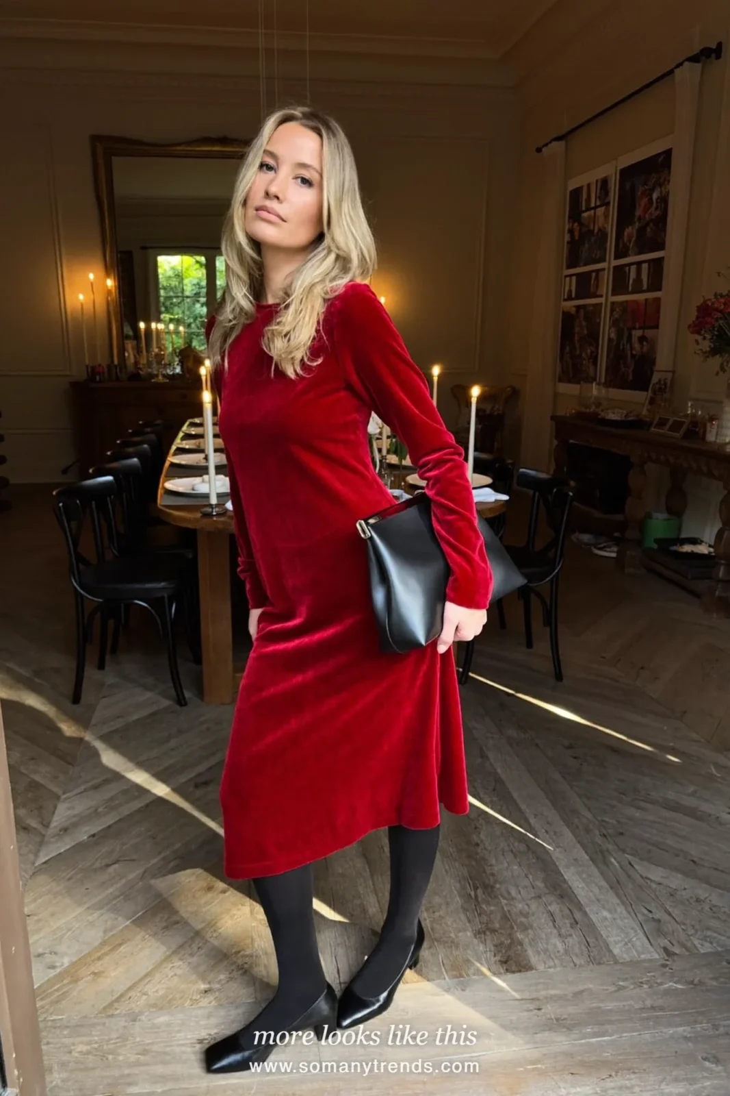 Woman in a deep red velvet long-sleeve midi dress, black pumps and clutch at a Christmas dinner, outfit 25