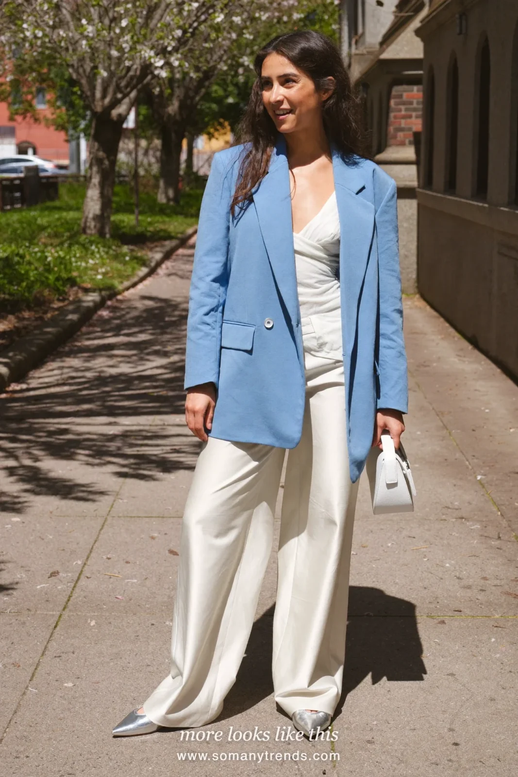 Woman in an icy blue relaxed blazer, white shell and wide ivory pants with silver flats, spring church outfit 19