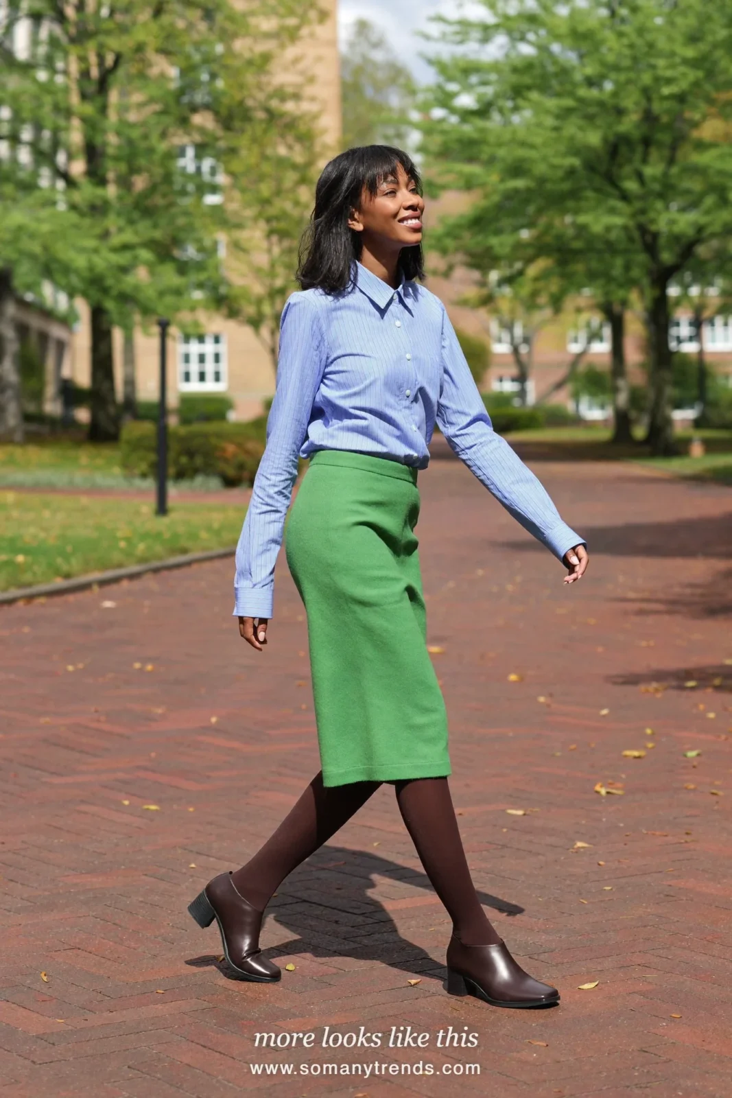 Woman wearing a striped oxford button-down shirt, pine green wool midi skirt, brown tights and brown block-heel ankle boots, winter graduation outfit 7