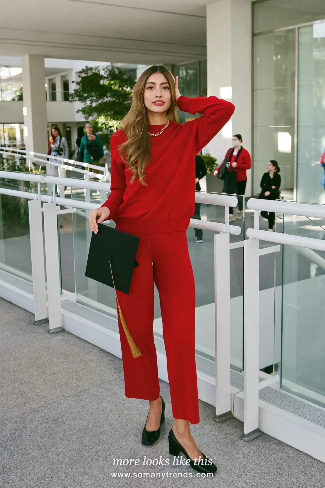Woman wearing a red fine-knit crewneck, matching wide-leg red knit pants, gold chain necklace and black closed block-heel pumps, winter graduation outfit 23