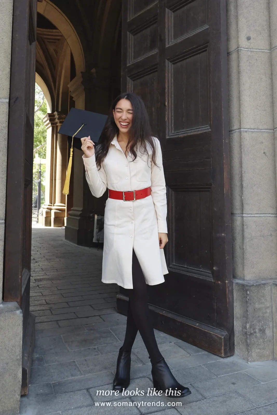 Woman wearing an ivory long-sleeve midi shirt dress, wide red leather belt, black opaque tights and black block-heel ankle boots, winter graduation outfit 25