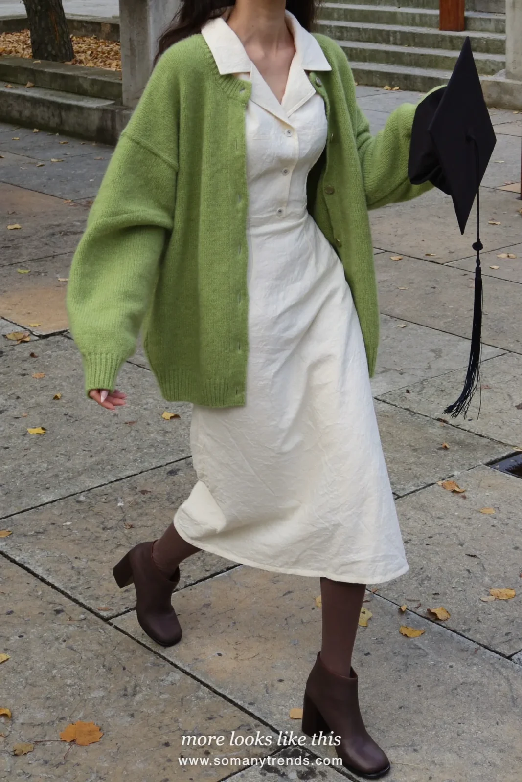 Woman wearing a cream collared midi dress, pine green cardigan, brown opaque tights and brown block-heel ankle boots, winter graduation outfit 27