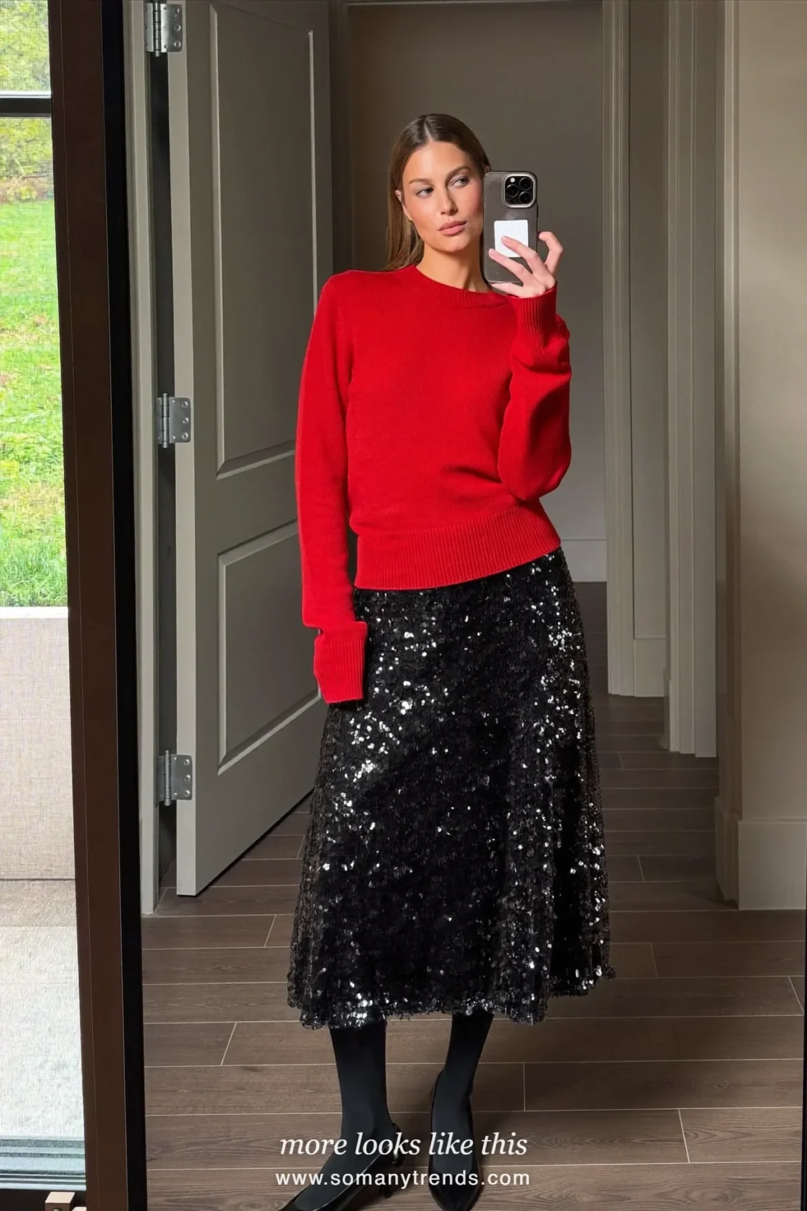 Woman in a cherry red fine knit sweater, black sequin midi skirt and black pumps, outfit 16