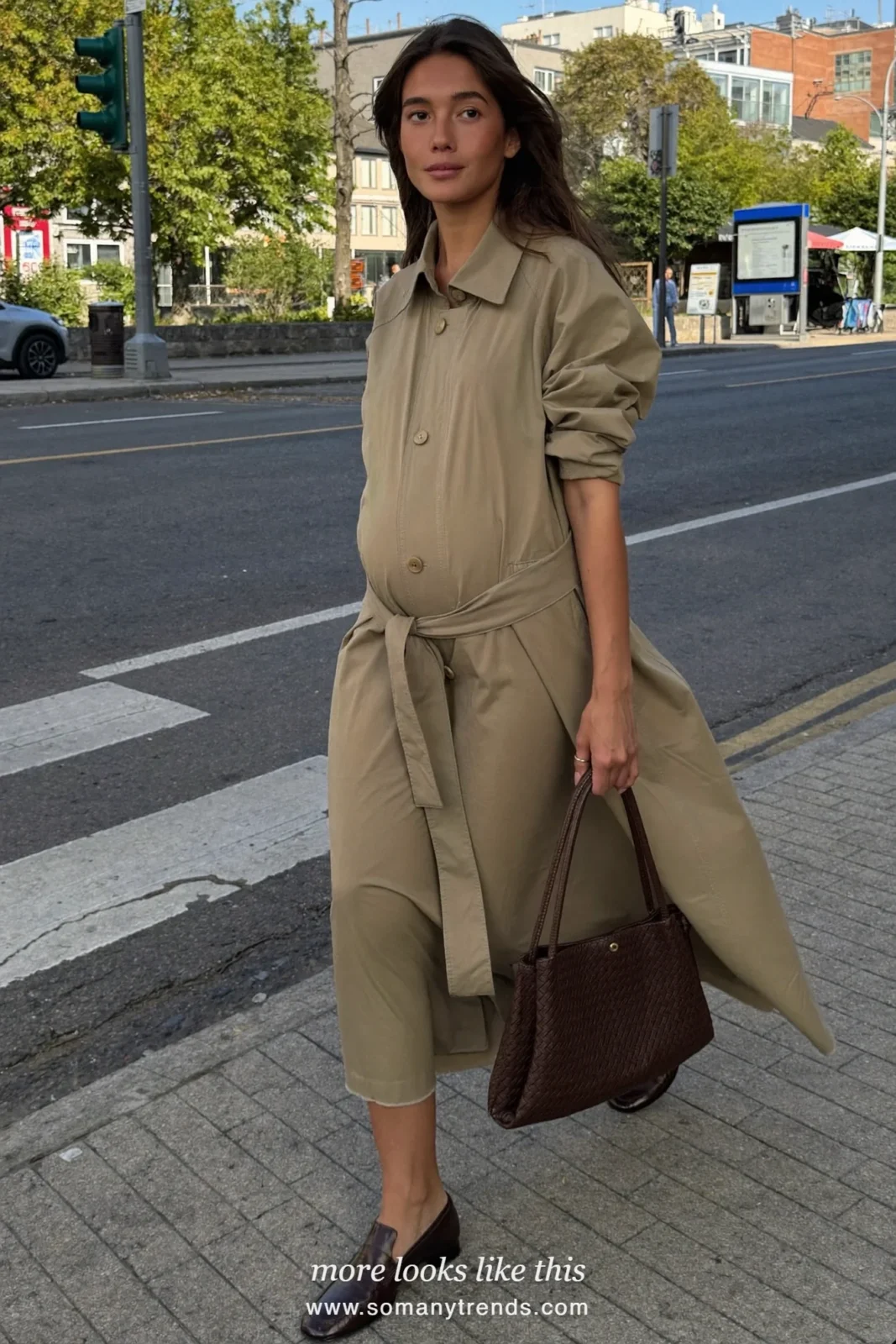 Woman with a baby bump in a stone beige trench dress and brown loafers, outfit 23