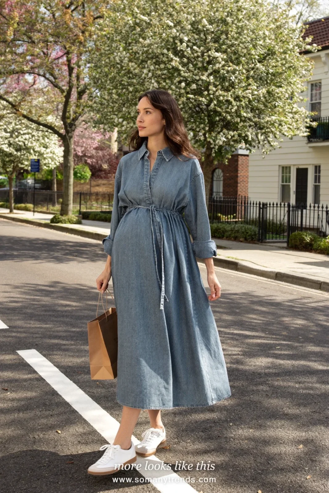 Woman with a baby bump in a long faded blue shirt dress and white sneakers, outfit 3