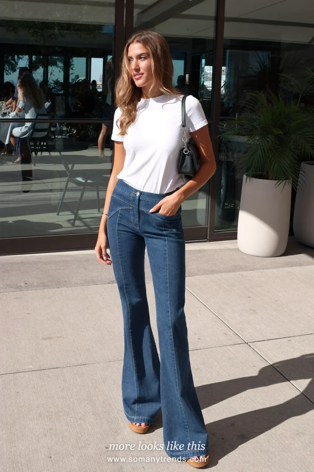 Look 25: fitted white tee, dark flared jeans and tan platform sandals