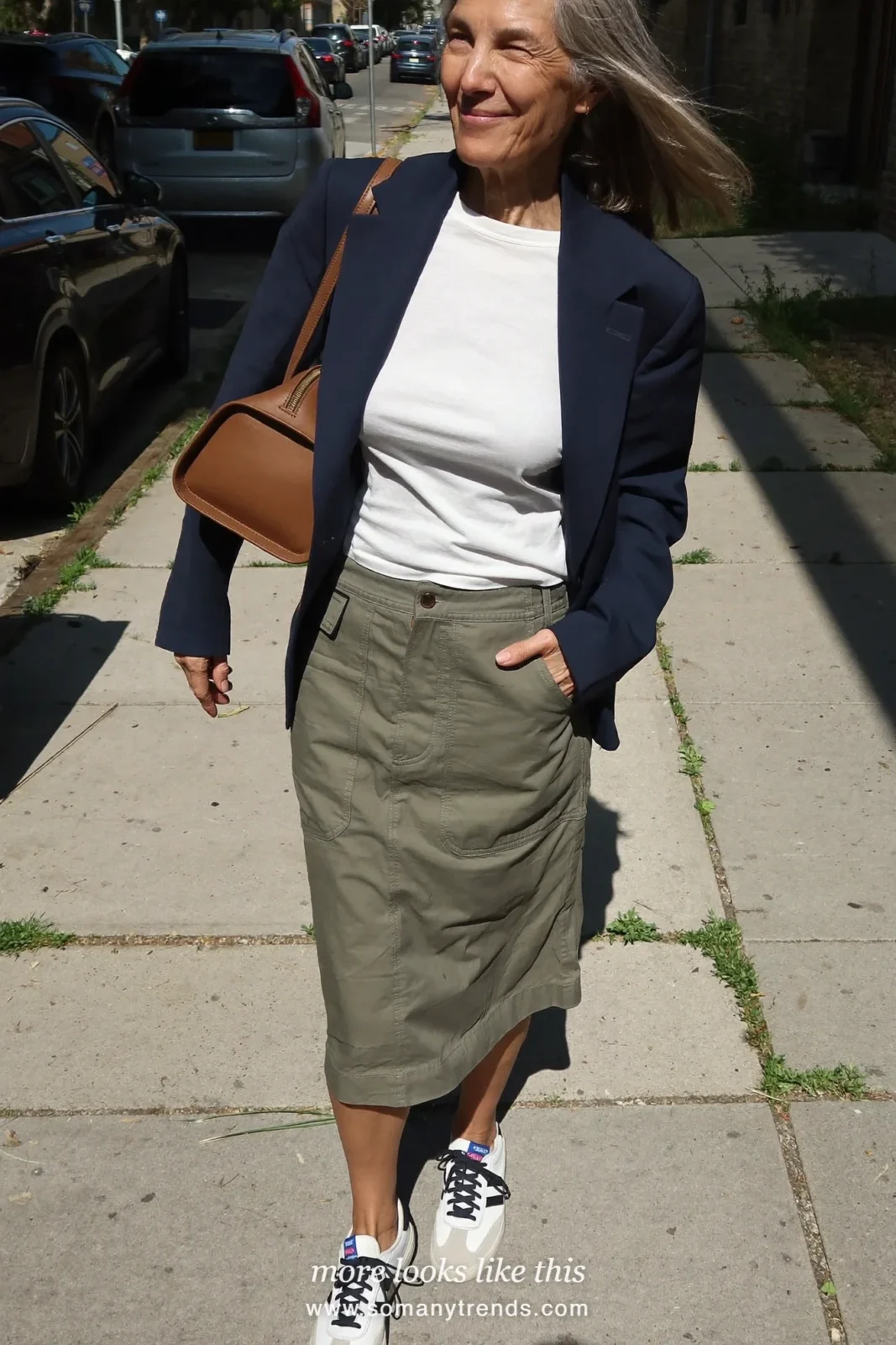 Woman in her forties wearing olive utility midi skirt, white tee, navy relaxed blazer and white leather sneakers, outfit 9