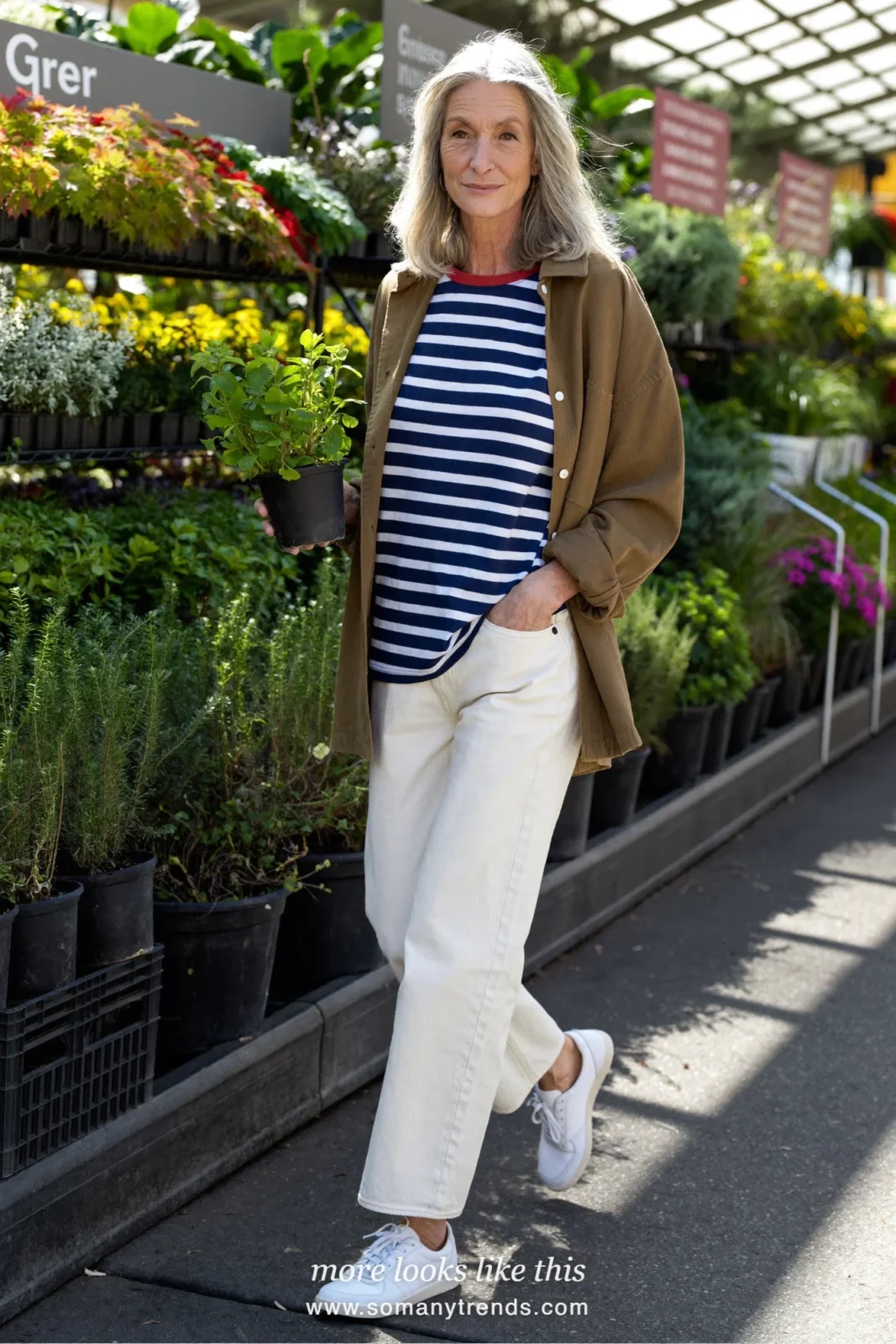 Woman in her forties wearing olive twill overshirt, navy striped tee, cream straight jeans and white leather sneakers, outfit 18