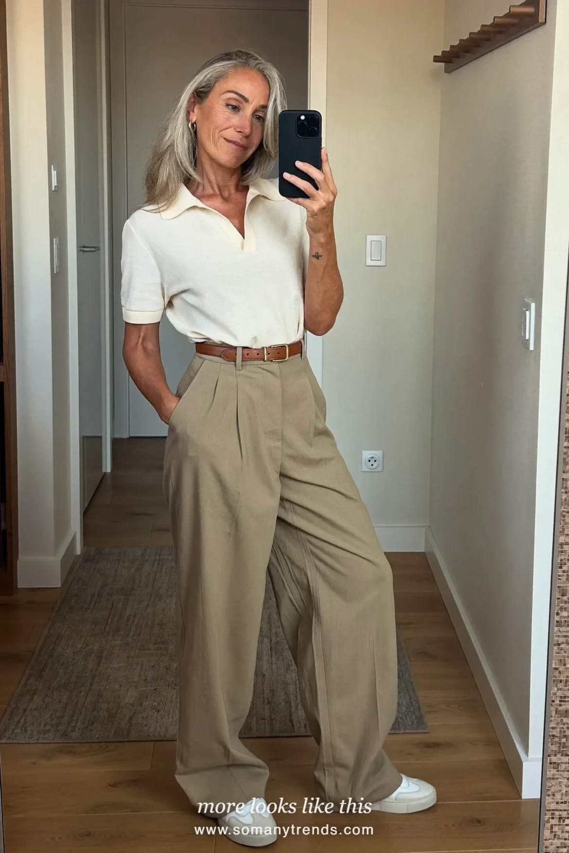 Woman in her forties wearing cream fine-knit polo, khaki wide-leg pants, light brown belt and white sneakers, outfit 20