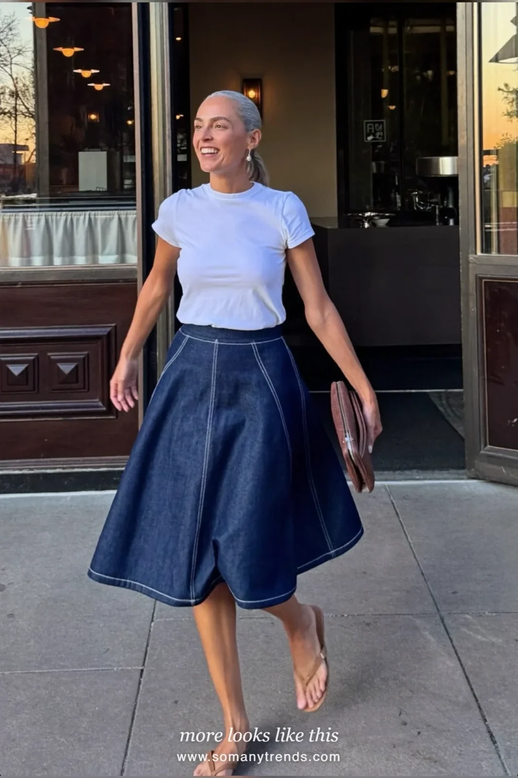 Woman in her forties wearing white cotton tee, indigo double-layer midi skirt and tan flat sandals, outfit 22