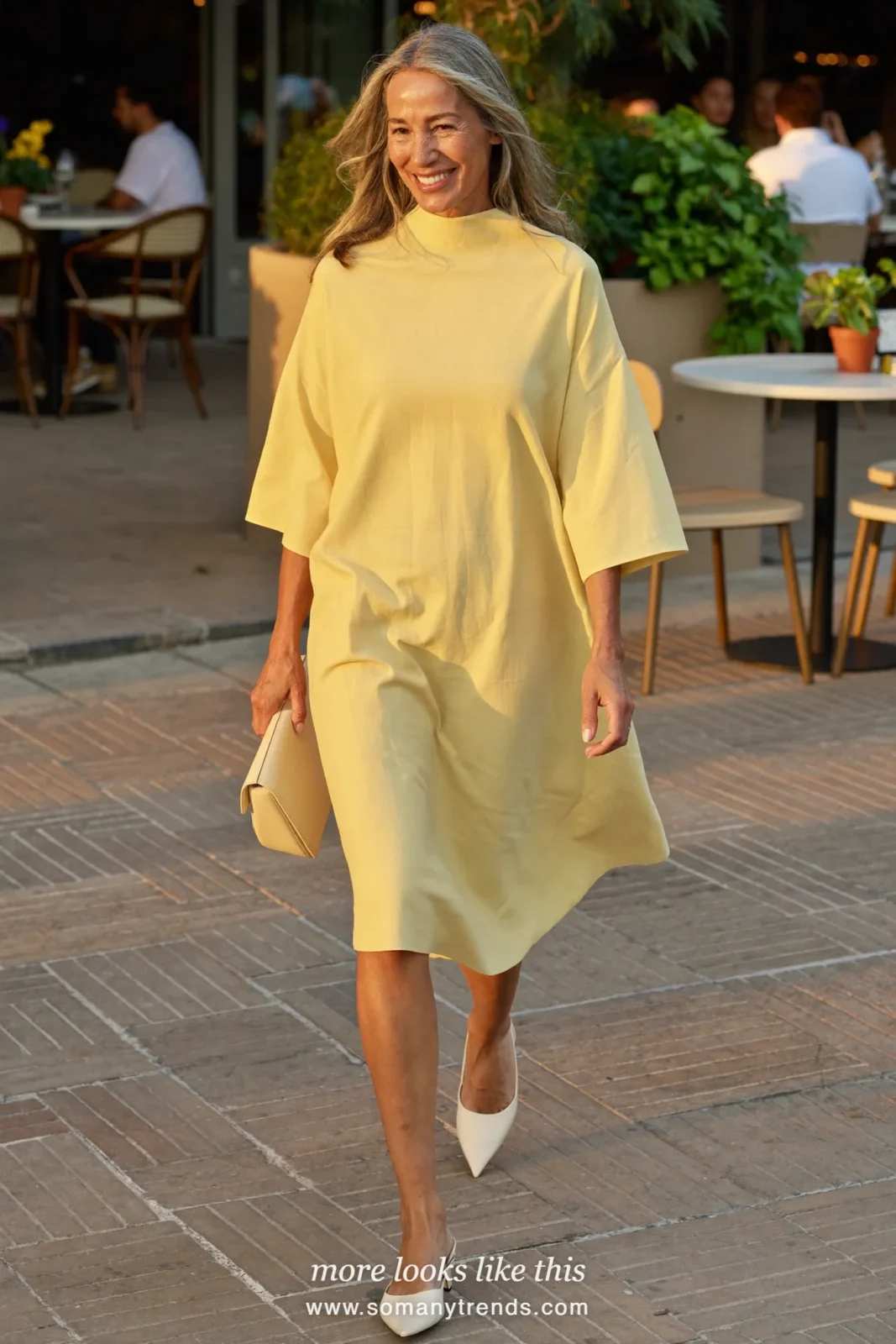 Woman in her forties wearing butter yellow high-neck crepe midi dress and cream slingback pumps, outfit 25