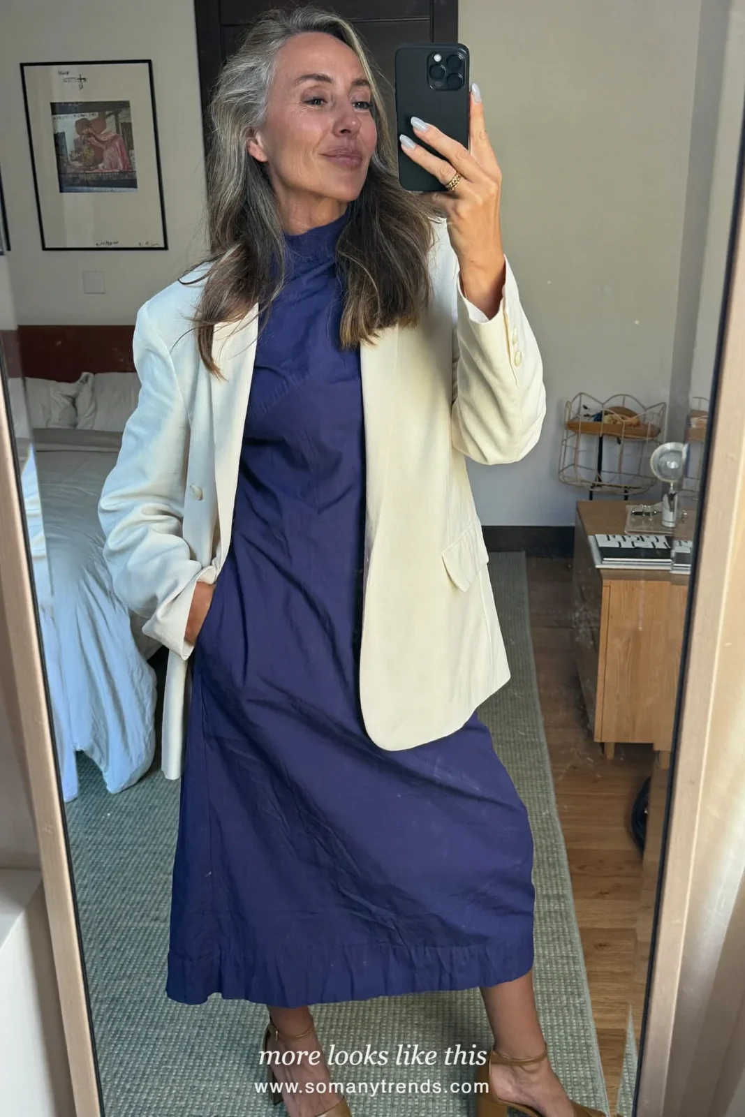 Woman in her forties wearing indigo high-neck midi dress, cream relaxed blazer and tan block-heel sandals, outfit 28