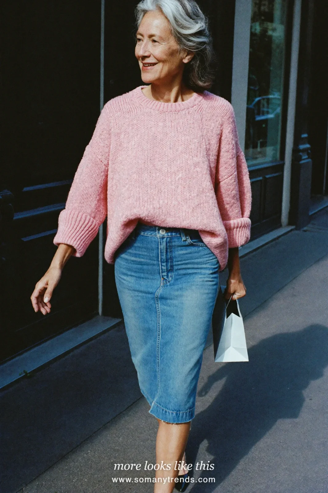 Woman over 50 in a denim midi pencil skirt, oversized dusty pink knit and pointed flats, outfit 7