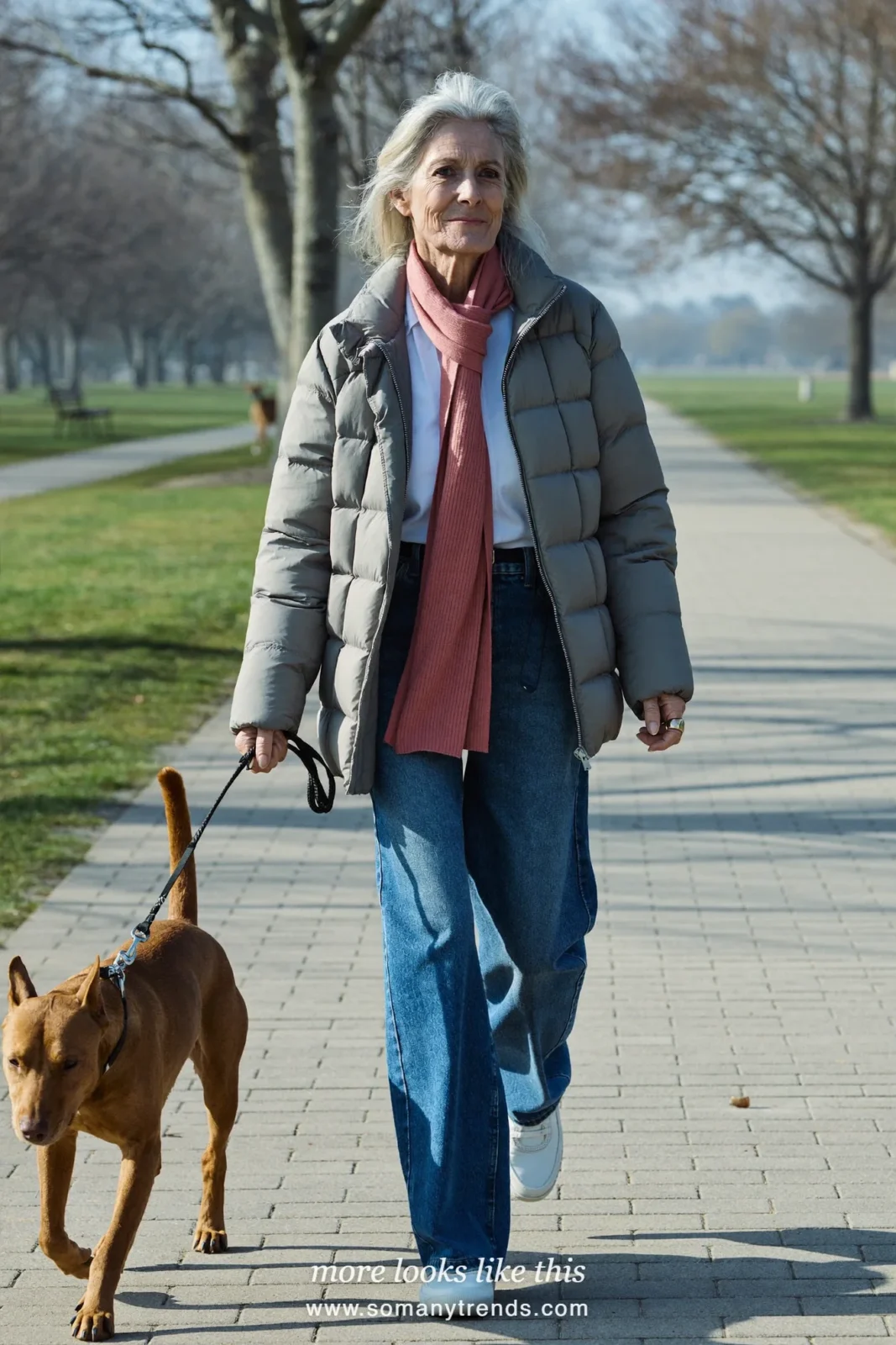 Woman over 50 in a gray lightweight quilted jacket, white shirt, straight jeans and sneakers, outfit 21