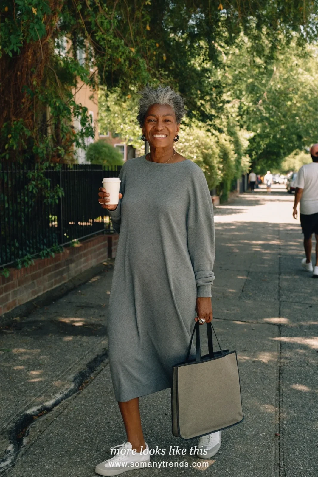 Woman over 50 in a loose long gray lightweight knit dress with white sneakers, outfit 27