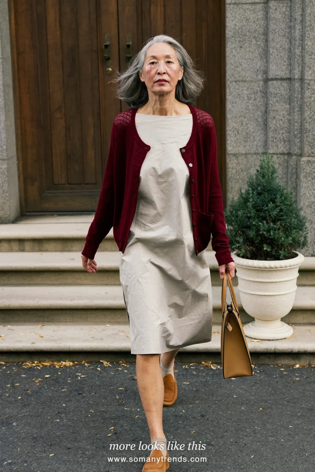 Woman over 50 in a burgundy cardigan over a pale gray cotton midi dress and tan loafers, outfit 22