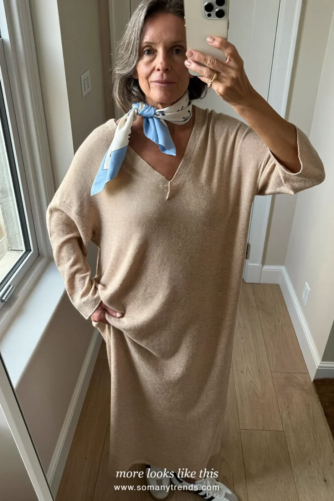 Woman in her seventies in an oatmeal knit maxi dress, silk scarf and white sneakers, look 16