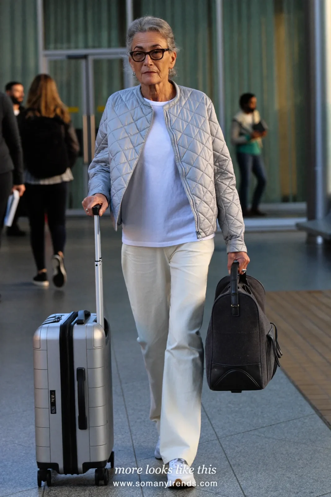 Woman in her seventies in a silver gray quilted jacket, white tee, soft pants and sneakers, look 21