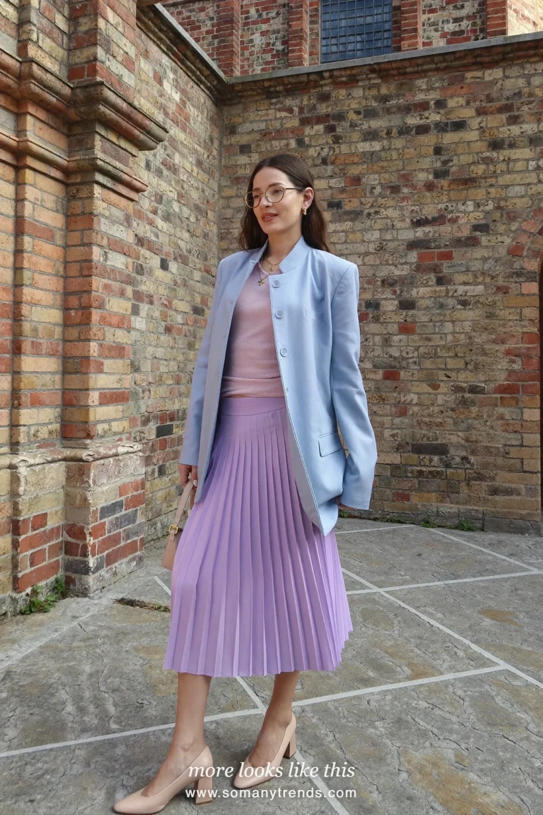 Woman in a powder blue blazer, lilac midi skirt and block heels outside a church, wedding guest outfit 19