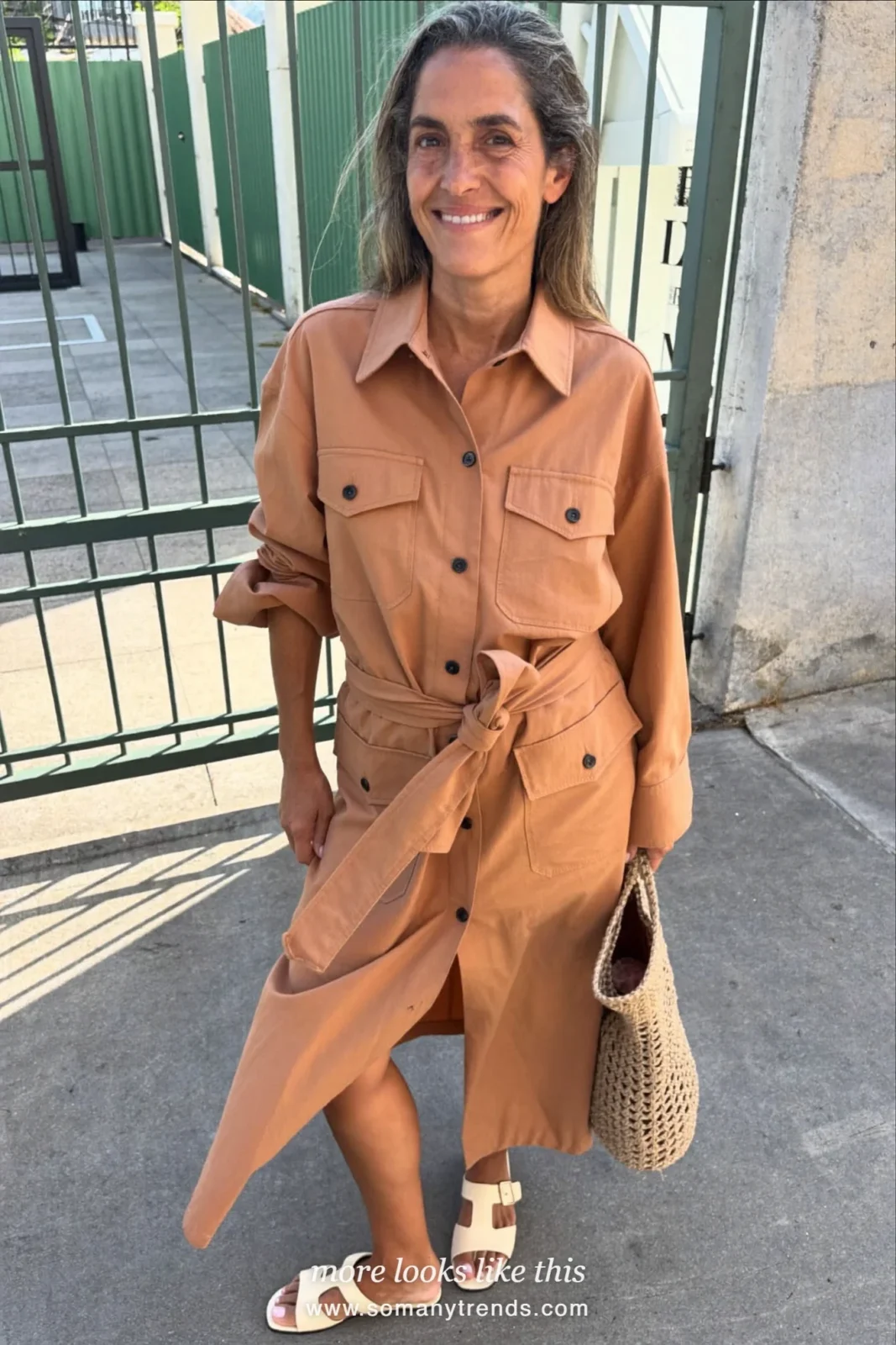 Woman in her forties wearing terracotta belted cotton shirt dress and cream flat sandals, outfit 7
